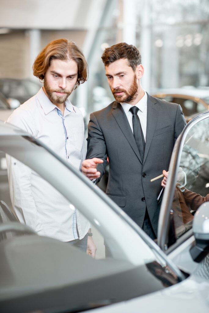 Salesperson with client in the car showroom
